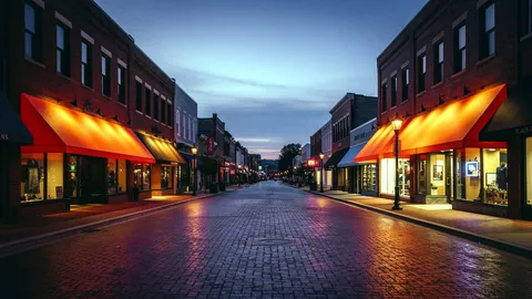 Illustration: An Atlanta street with shop signs glowing at dusk.