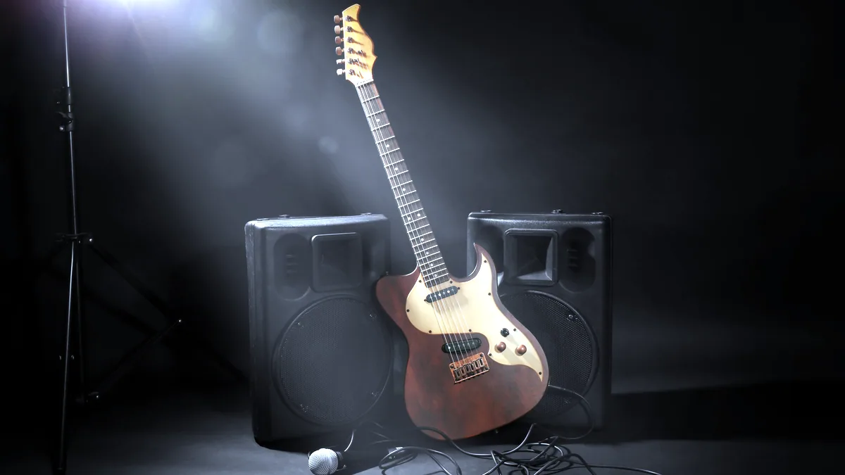 A vintage electric guitar on a stand under dim blue stage light.