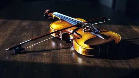 Illustration: A folk fiddle and bow resting on a wooden table.
