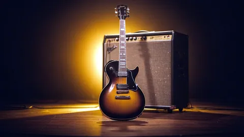 Illustration: An electric guitar in front of a glowing amp on a small stage.