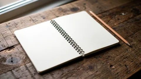 Illustration: An open ruled notebook and a wooden pencil on an oak tabletop.