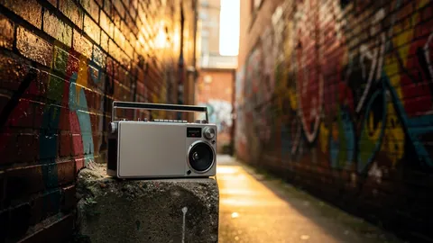 Illustration: A boombox on a ledge in a graffiti covered alley.