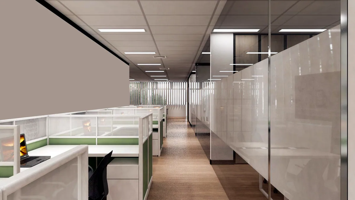 A long corridor of desks in a small music company office.
