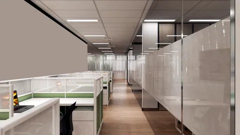 A long corridor of desks in a small music company office.